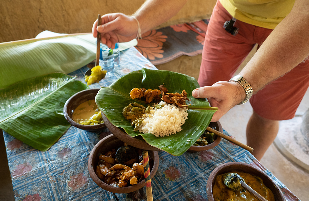 Sri Lankan rice and curry served in traditional rural kitchen.